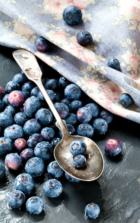 Serving of Yogurt with Whole .Fresh Blueberries and Oatmeal on Old Rustic Table.の写真素材
