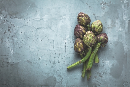 Vegetable background with fresh artichokes grey background.の写真素材