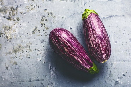 Fresh purple eggplant graffiti on empty wooden backgroundの写真素材