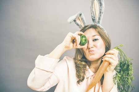 Funny woman with fresh carrot. Picture with space for your text.