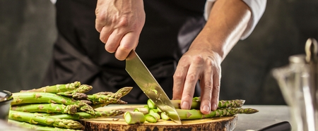 Green asparagus kept in men's Chef cook handsの写真素材