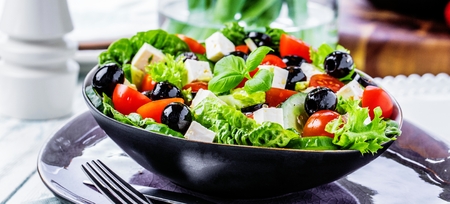 Fresh vegetables greek salad . Healthy food on wooden backgroundの写真素材