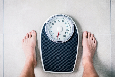 Close-up Weighing Scale ,Men standing on weigh scales