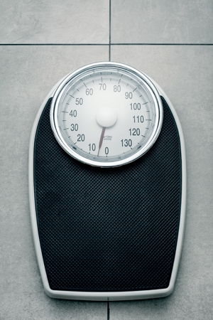 Close-up Weighing Scale in bathroom on stone groundの写真素材