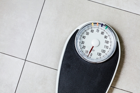 Close-up Weighing Scale in bathroom on stone ground