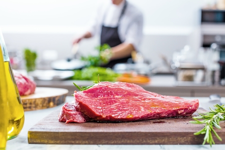 Chef in restaurant kitchen cookingの写真素材