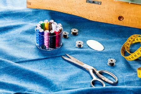 background table top view of sewing tool and jeans on denim fabric.の写真素材