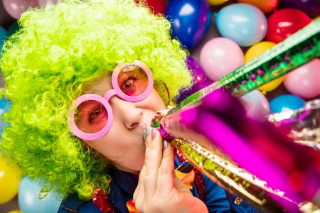 Portrait of beautiful party woman in wig and glasses Carnevalの写真素材