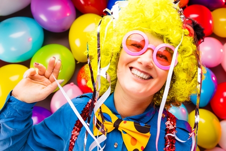 Portrait of beautiful party woman in wig and glasses Carnevalの写真素材