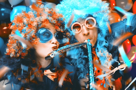 Women and men celebrating at party for new years eve or carnivalの写真素材