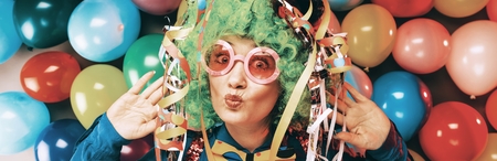 Portrait of beautiful party woman in wig and glasses Carnevalの写真素材
