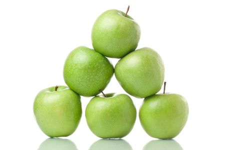 Green apple pyramid. Ripe green apples isolated on white backgroundの写真素材
