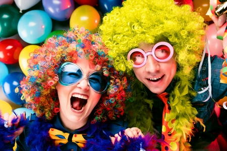 Women and men celebrating at party for new years eve or carnivalの写真素材