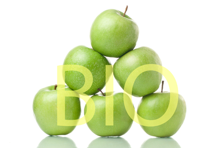 Green apple pyramid. Ripe green apples isolated on white background with Bio textの写真素材