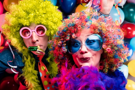 Women and men celebrating at party for new years eve or carnivalの写真素材