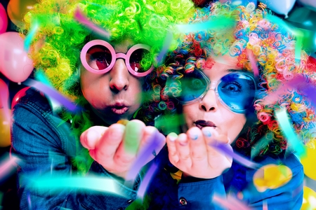 Women and men celebrating at party for new years eve or carnivalの写真素材