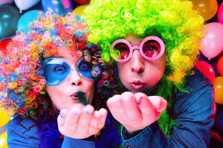 Women and men celebrating at party for new years eve or carnivalの写真素材