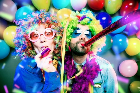 Women and men celebrating at party for new years eve or carnivalの写真素材