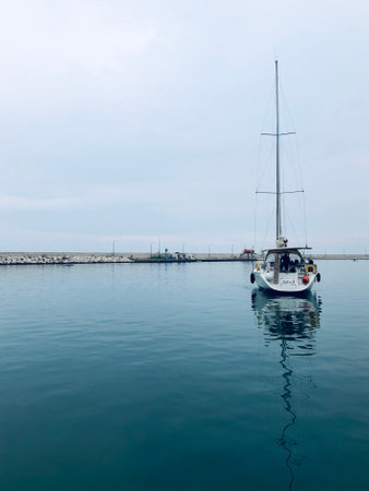 Sailboat in the sea on a cloudy day, view from aboveの写真素材