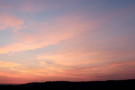Windmills in the distance on a colorful morning near Potzbach, Germany at sunrise.