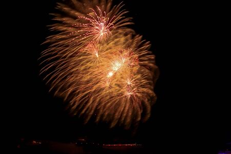 Gold fireworks above the Ehrenbreitstein Fortress in Koblenz, Germany against a black sky.のeditorial素材
