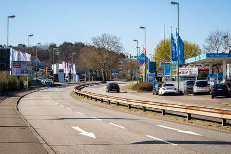 Very few people driving on what is normally a very busy road on a weekday in Kaiserslautern, Germany.のeditorial素材