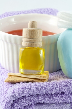 Aromatic pleasure  Fragrance oil, violet towel,  blue soap and herbal massage oil  Close upの写真素材