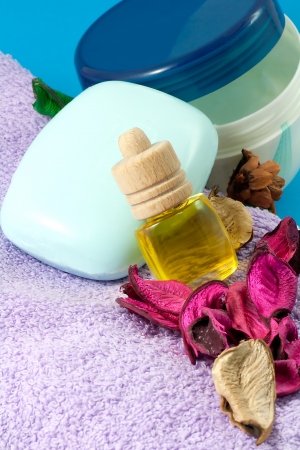 Aromatic pleasure  Fragrance oil, violet towel,  blue soap and refreshing body cream  Close upの写真素材