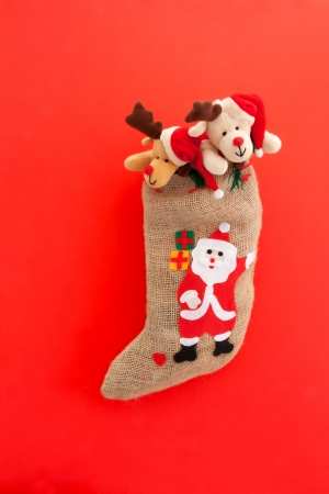 Christmas stocking with Santa Claus  On red background の写真素材