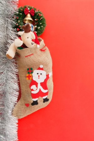 Christmas stocking with Santa Claus  On red background の写真素材