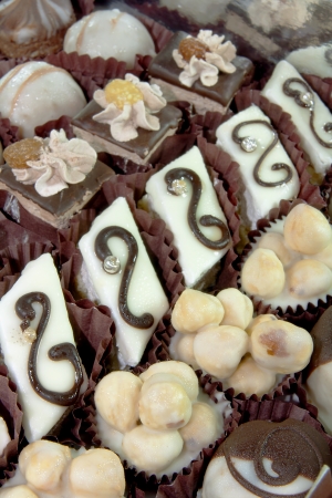 Beautiful mixed cakes with white cream, chocolate, raisin and hazelnut の写真素材