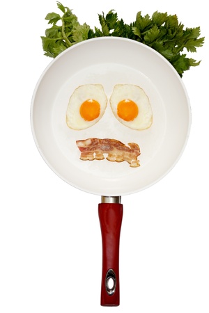 Mr. BREAKFAST Jr. Two fried eggs with bacon in white pan. Parsley for decor. Isolation on white.の写真素材