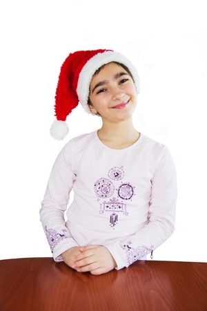 Smiling girl in a Santa Claus hat. Isolated on whiteの写真素材
