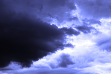 Dark Clouds in the Sky over Sun, Blue Toning. Abstract Background.の写真素材