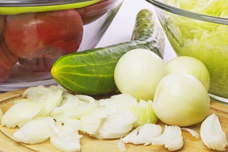 Chopped Onion and Fresh Vegetables in a Glass Bowl. Close up. Organic Food.の写真素材