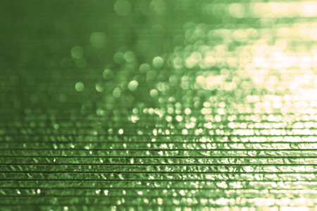 Abstract and Festive Background with Green Glitter. Illuminated in the Corner.の写真素材