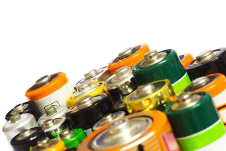 Group of Old AA, AAA and C Batteries in Closeup on White. Selective Focus.