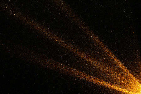 Abstract and Festive Background with Golden Glitter. Illuminated in the Corner.
