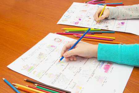 Hand with Colored Pencil Drawing Homework. School Concept.の写真素材