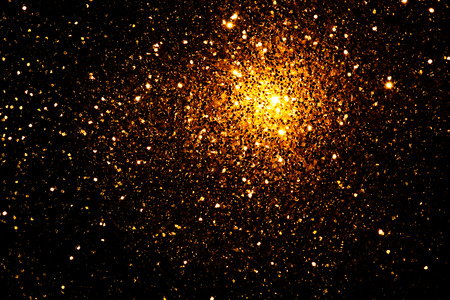 Abstract and festive background with golden yellow lights. Defocused blurred lights.の写真素材
