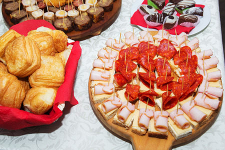 Table with mix of different finger food snacks for a party.の写真素材