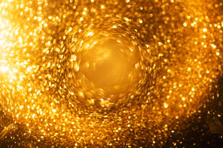 Abstract and festive background with golden yellow lights. De focused blurred lights.の写真素材