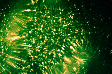 Abstract and festive background with golden yellow lights. De focused blurred lights.