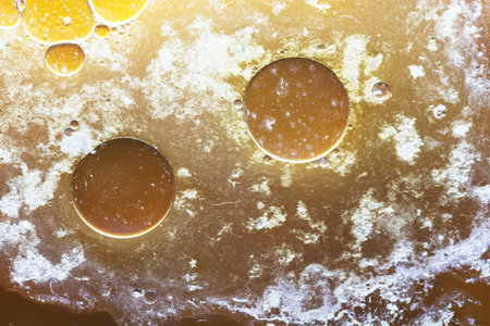 Abstract background with liquid and drops over a blurred backdrop, close up.の写真素材