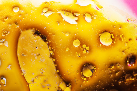 Abstract background with liquid and drops over a blurred backdrop, close up.の写真素材