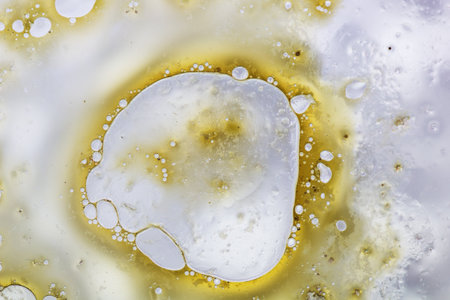 Abstract background with liquid and drops over a blurred backdrop, close up.の写真素材