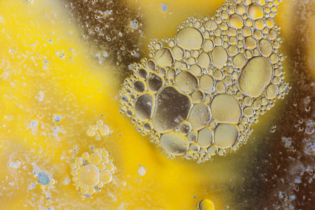 Abstract background with liquid and drops over a blurred backdrop, close up.の写真素材