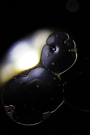 Abstract background with liquid and drops over a blurred backdrop, close up.の写真素材