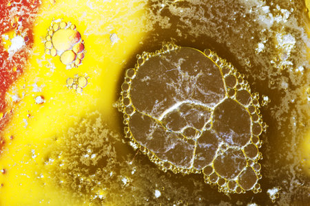 Abstract background with liquid and drops over a blurred backdrop, close up.の写真素材