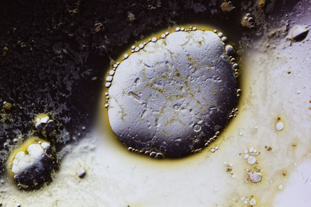 Abstract background with liquid and drops over a blurred backdrop, close up.の写真素材